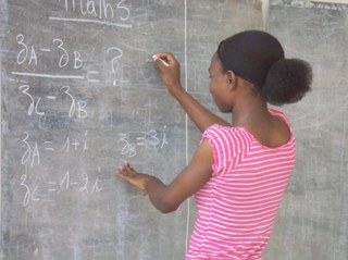 A girl writing on the blackboard, Cameroon