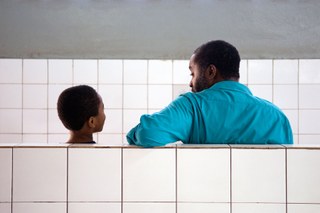 Man and son waiting in a medical centre in Gambia Man and son waiting in a medical centre in Gambia