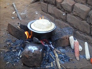 Preparing nsima on a tripod Preparing nsima on a tripod