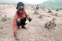 A child sits on barren land, Rwanda A child sits on barren land, Rwanda