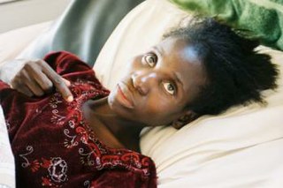 A woman lying sick in bed