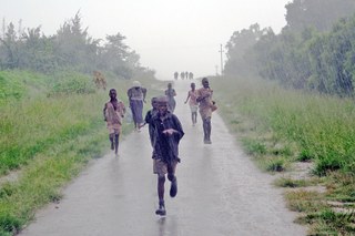 Children running in the rain in Zimbabwe